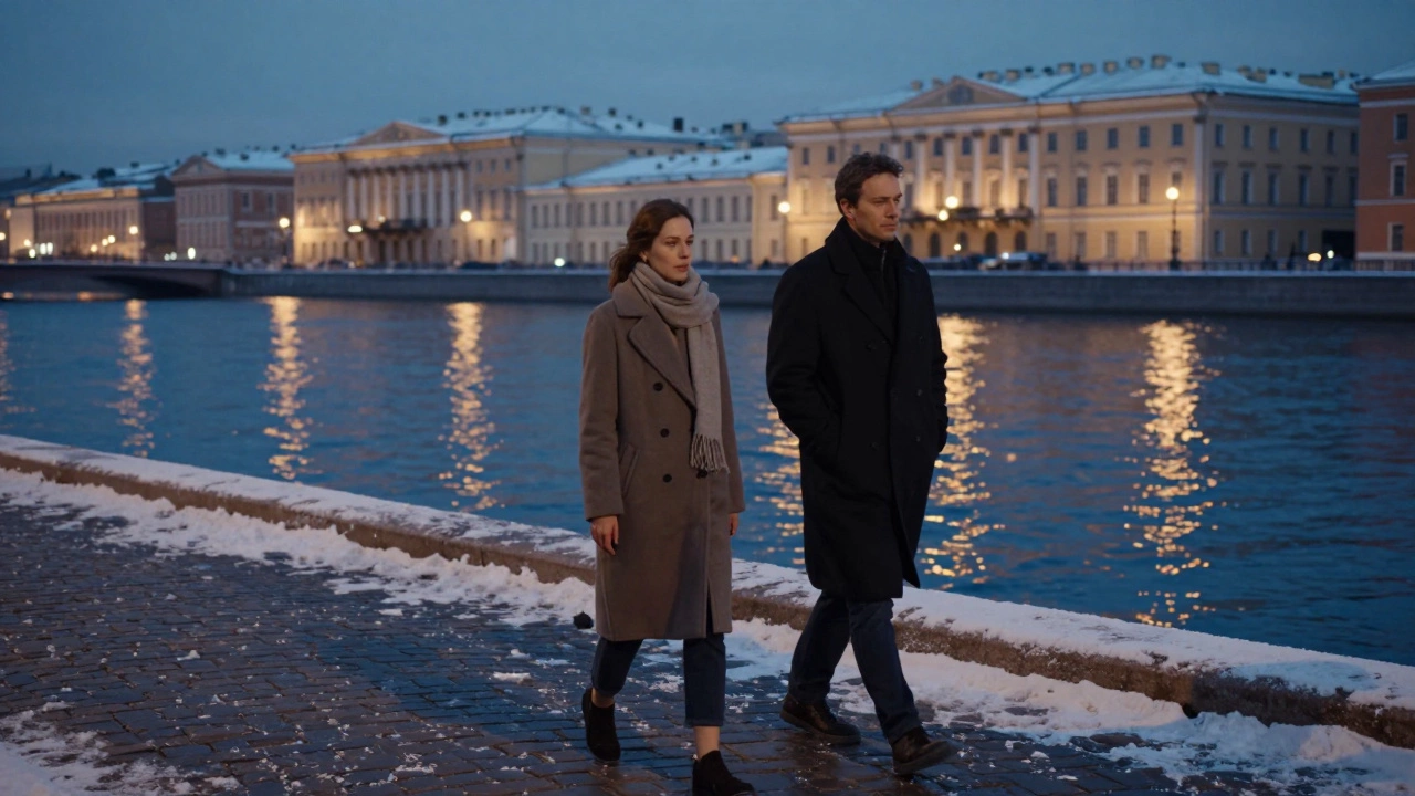 A woman and man walk side by side along a snowy riverbank in St. Petersburg at dusk.